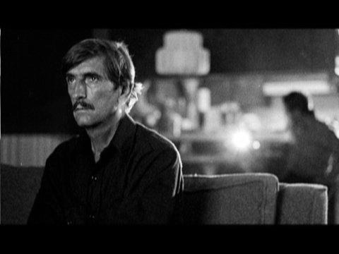 Travis watches the Super 8 film